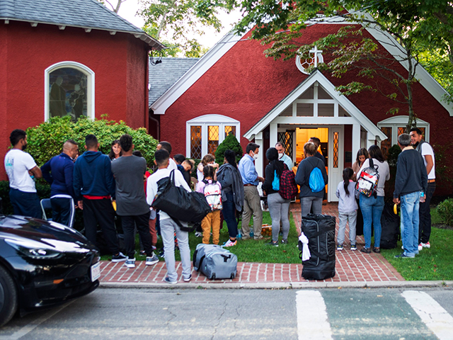 Immigrants gather with their belongings outside St. Andrews Episcopal Church, Wednesday Se