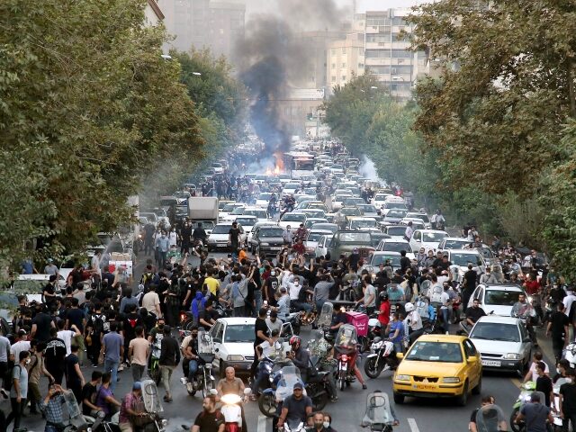 FILE - In this photo taken by an individual not employed by the Associated Press and obtained by the AP outside Iran, protesters chant slogans during a protest over the death of a woman who was detained by the morality police, in downtown Tehran, Iran, Sept. 21, 2022. (AP Photo, …