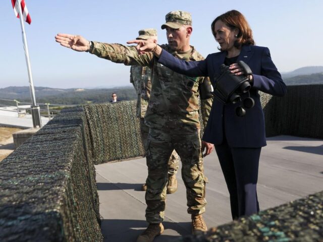 U.S. Vice President Kamala Harris, right, uses binoculars at the military observation post as she visits the demilitarized zone (DMZ) separating the two Koreas, in Panmunjom, South Korea Thursday, Sept. 29, 2022. (Leah Millis/Pool Photo via AP)