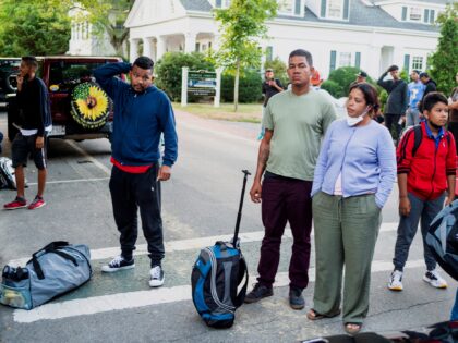 Immigrants gather with their belongings outside St. Andrews Episcopal Church, on Sept. 14, 2022, in Edgartown, Mass., on Martha's Vineyard.Ray Ewing / Vineyard Gazette via AP