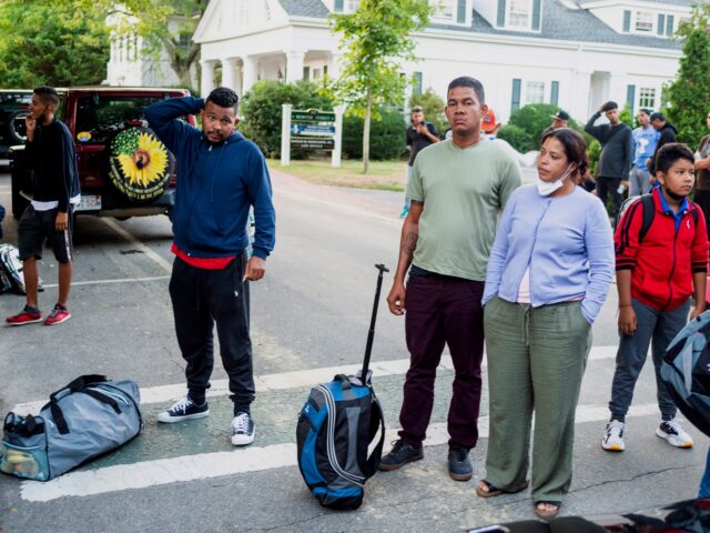 Immigrants gather with their belongings outside St. Andrews Episcopal Church, on Sept. 14,