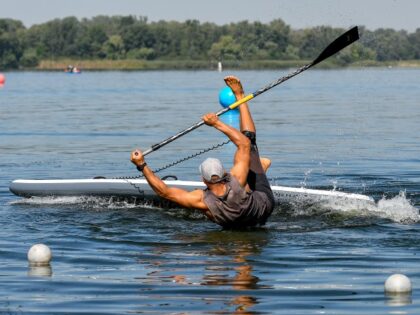 ZAPORIZHZHIA, UKRAINE - AUGUST 29, 2020 - A man practices standup paddleboarding on the Dnipro River during the weekend by the Dnipro show of water sports, Zaporizhzhia, southeastern Ukraine.- (Dmytro Smolyenko/ Ukrinform/Future Publishing via Getty Images)