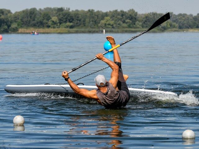 ZAPORIZHZHIA, UKRAINE - AUGUST 29, 2020 - A man practices standup paddleboarding on the Dn