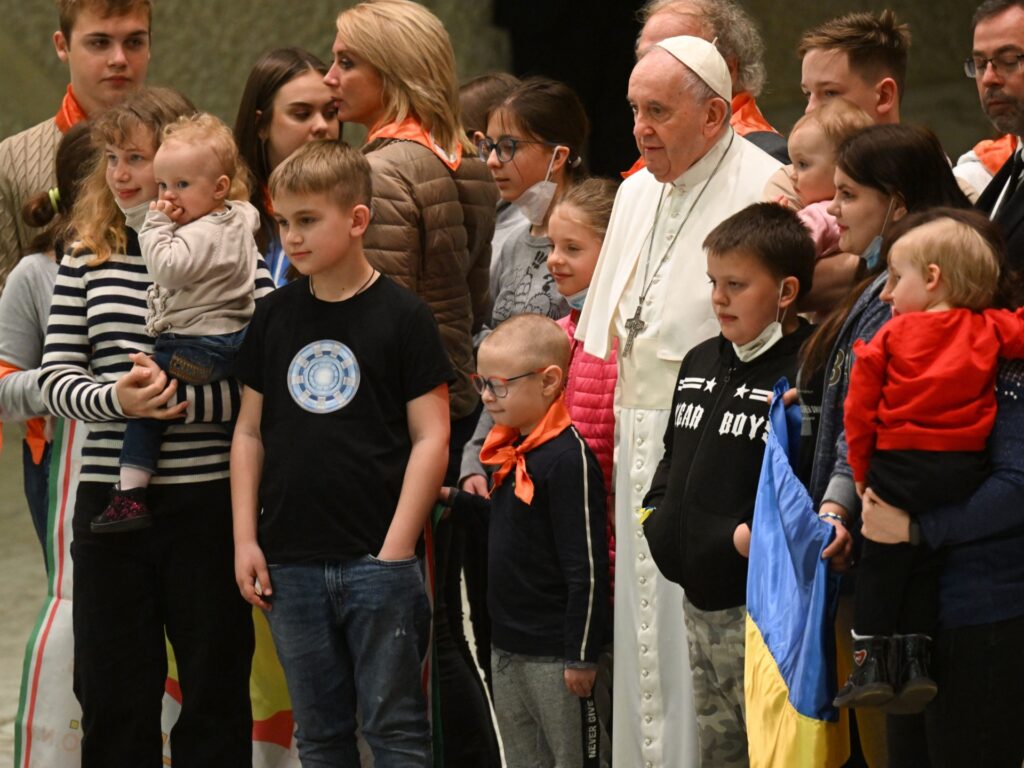 Pope Francis poses with refugees from Ukraine during the weekly general audience on March 30, 2022 at Paul-VI hall in The Vatican. (Photo by Andreas SOLARO / AFP) (Photo by ANDREAS SOLARO/AFP via Getty Images)