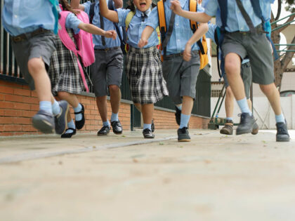 School children running low angle - stock photo