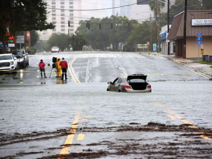 ORLANDO, FLORIDA, UNITED STATES - SEPTEMBER 29: A car in seen abandoned in a flooded road due to heavy rains from Hurricane Ian on September 29, 2022 in Orlando, Florida. The storm has caused widespread power outages and flash flooding in Central Florida as it crossed through the state after …