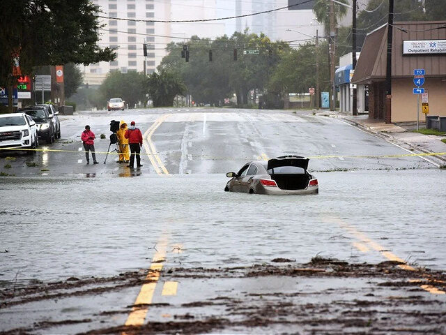 ORLANDO, FLORIDA, UNITED STATES - SEPTEMBER 29: A car in seen abandoned in a flooded road