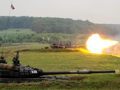 TOPSHOT - Picture taken on July 1, 2010 shows Russian tanks firing off rounds during the "