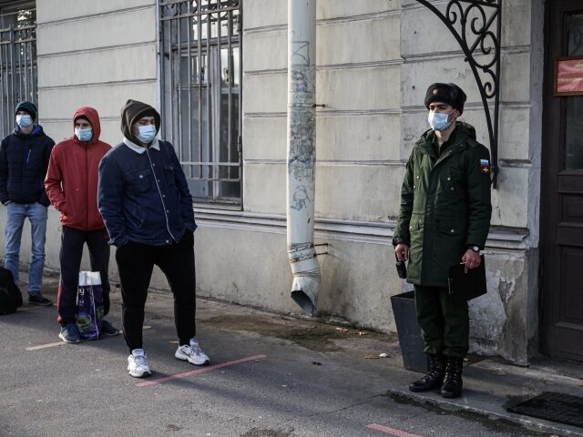 People in protective masks in the queue in front of the conscription point in the Russian army, in Saint Petersburg, Russia, on October 20, 2020. (Photo by Valya Egorshin/NurPhoto via Getty Images)