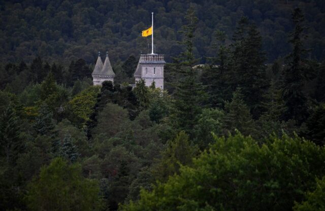 The departure of Queen Elizabeth II's oak casket from Balmoral Castle, where a flag flew a