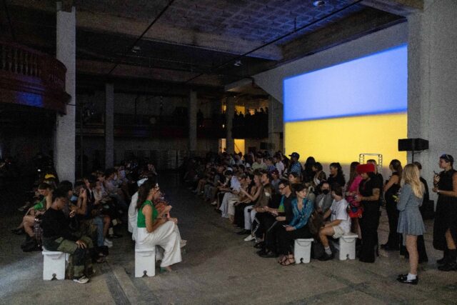 The flag of Ukraine is projected on a wall at a showcase of designs by Svitlana Bevza in N