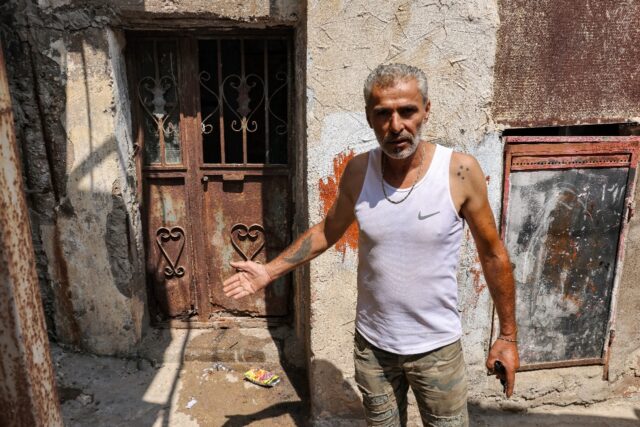 Najib al-Khatib, 52, indicates a place that was laden with corpses after the Sabra and Sha