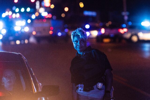 Police investigate the scene of a carjacking related to the Memphis shooting spree