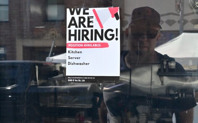 A 'We Are Hiring' sign is seen in front of a restaurant in Los Angeles, California in August 2022