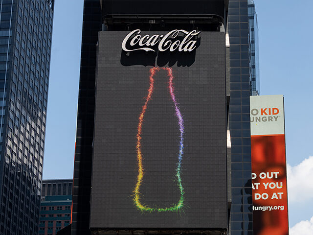 NEW YORK, NEW YORK - JUNE 22: The Coca-Cola digital billboard lights up with a rainbow out