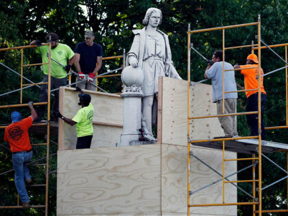 City worker cover the statue of Christopher Columbus at Marconi Plaza, Tuesday, June 16, 2