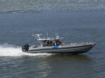 A Brownsville, Texas, based AMO Costal Interceptor moves out to rescue four migrants from
