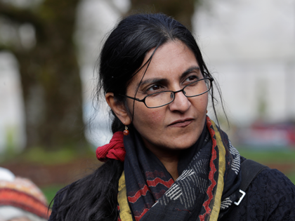 Seattle city councilmember Kshama Sawant listens as she appears at a rally in support of h