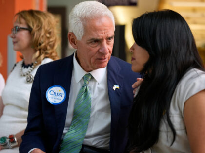 Florida Democratic gubernatorial candidate Charlie Crist speaks with his running mate Karla Hernandez-Mats during an event with former Rep. Gabrielle Giffords of Arizona, at Florida International University, Monday, Sept. 12, 2022, in Miami. State Democratic officials and candidates joined with Giffords for events on Monday as she continued her Florida …