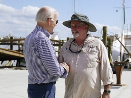 President Joe Biden talks with Fort Myers Beach Mayor Ray Murphy as he tours the area impacted by Hurricane Ian on Wednesday, Oct. 5, 2022, in Fort Myers Beach, Fla. (AP Photo/Evan Vucci)