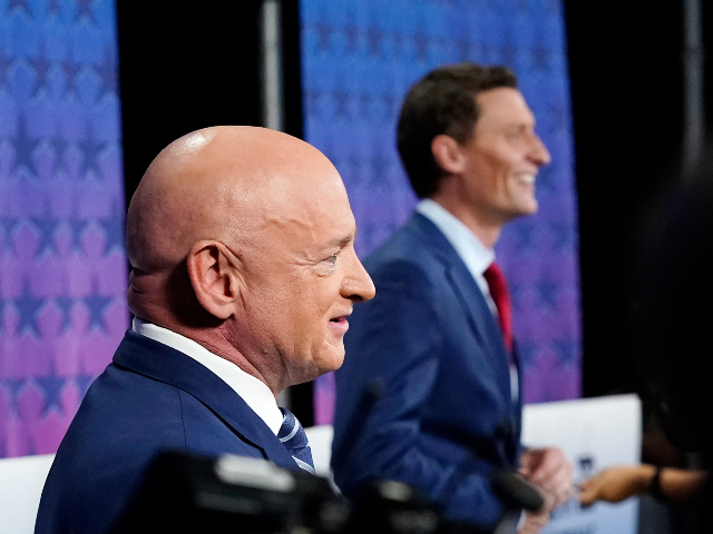 Arizona Democratic Sen. Mark Kelly, left, and his Republican challenger Blake Masters, right, pause on stage prior to a televised debate in Phoenix, Thursday, Oct. 6, 2022. (AP Photo/Ross D. Franklin)