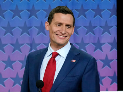 Republican Senate challenger Blake Masters smiles on stage prior to a televised debate wit