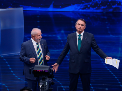 Brazil's former President Luiz Inacio Lula da Silva, who is running for office again, left, faces Jair Bolsonaro in a presidential debate at Bandeirantes Television in Sao Paulo, Brazil, Sunday, Oct. 16, 2022. The presidential runoff election is set for Oct. 30. (AP Photo/Marcelo Chello)
