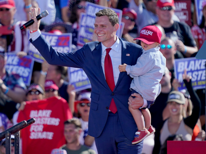 U.S. Sen. Republican candidate Blake Masters holds his son, Rex, 2, as he speaks at a rall