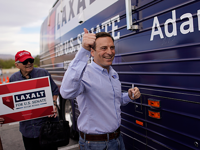 Republican Nevada Senate candidate Adam Laxalt motions after signing his campaign bus duri