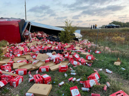 A truck packed with cans of Budweiser beer crashed on I-135 in Kansas early Tuesday, which sent its cargo flying everywhere.