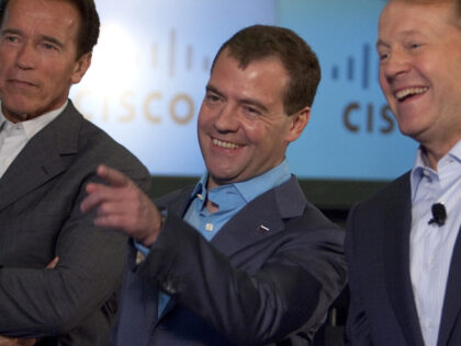 SAN JOSE, CA - JUNE 23: Russian President Dmitry Medvedev (C) laughs with Cisco Chairman and CEO John Chambers (R) and California Gov. Arnold Schwarzenegger during a demonstration at Cisco headquarters June 23, 2010 in San Jose, California. During the meeting Cisco Chairman and CEO John Chambers signed a Memorandum …