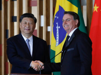TOPSHOT - Chinese President Xi Jinping (L) and Brazilian President Jair Bolsonaro shake hands during a press statement after their bilateral meeting at Itamaraty Palace in Brasilia, Brazil, on November 13, 2019. - Brazil's President Jair Bolsonaro walked a diplomatic tightrope, as he seeks to boost ties with Beijing and …