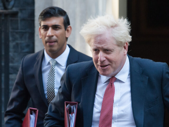 British Prime Minister Boris Johnson (R) and Chancellor of the Exchequer Rishi Sunak leave