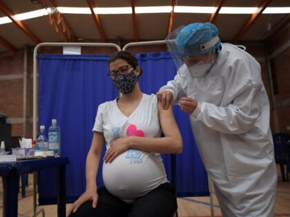 A pregnant woman receives a dose of the Pfizer-BioNTech vaccine against COVID-19 at a vaccination center in Bogota, on July 23, 2021. - Colombia started to inoculate pregnant women who have three months of gestation or more. (Photo by Raul ARBOLEDA / AFP) (Photo by RAUL ARBOLEDA/AFP via Getty Images)