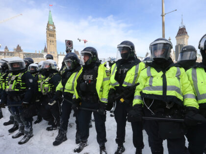 OTTAWA, ON- FEBRUARY 19 - Protesters from the "Freedom Convoy" in Ottawa are moved from Wellington Street in front of Parliament Hill by police officers after blockading the the downtown core of Canada's capitol for over three weeks. in Ottawa. February 19, 2022. The Freedom or Truckers Convoy is protesting …