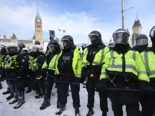 OTTAWA, ON- FEBRUARY 19 - Protesters from the "Freedom Convoy" in Ottawa are moved from Wellington Street in front of Parliament Hill by police officers after blockading the the downtown core of Canada's capitol for over three weeks. in Ottawa. February 19, 2022. The Freedom or Truckers Convoy is protesting …