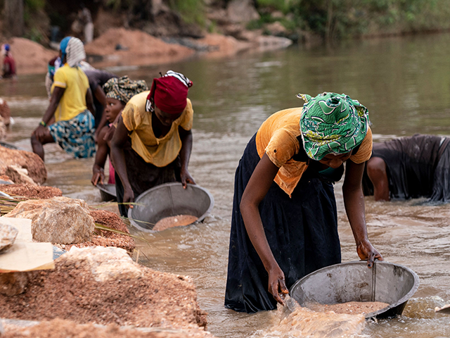 Artisanal miners collect gravel from the Lukushi river searching for cassiterite on Februa