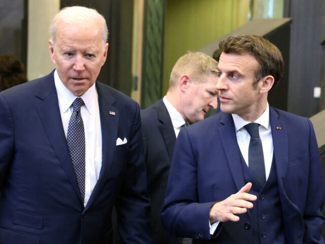 U.S. President Joe Biden (L) talks with French President Emmanuel Macron as they arrive to attend a North Atlantic Council meeting during a NATO summit at NATO Headquarters in Brussels on March 24, 2022. (Photo by Thomas COEX / AFP) (Photo by THOMAS COEX/AFP via Getty Images)
