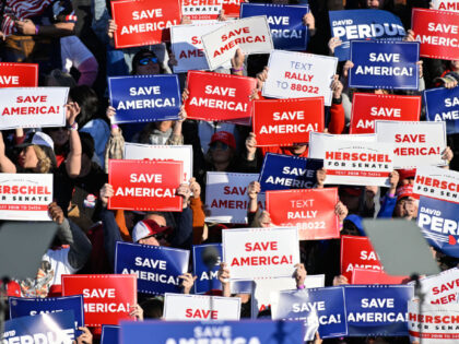 COMMERCE, USA - MARCH 26: People hold banners during former US President Donald J Trump's "Save America" rally with David Perdue, Burt Jones, Herschel Walker, Marjorie Taylor Greene and Vernon Jones in Commerce, GA, on March, 26, 2022. (Photo by Peter Zay/Anadolu Agency via Getty Images)