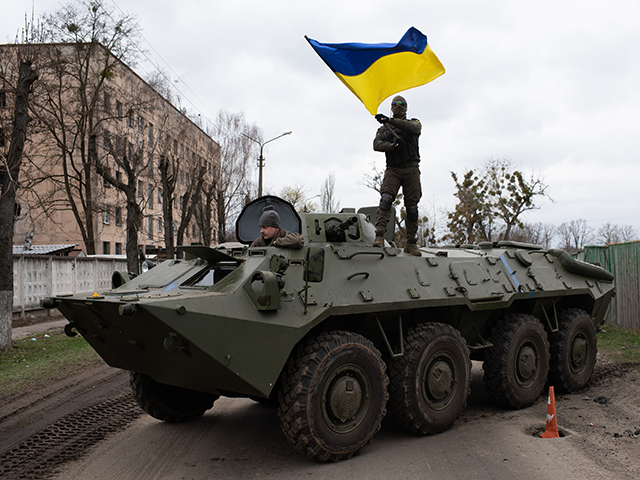Ukrainian soldier waves Ukrainian national flag while standing on top of an armoured personnel carrier (APC) on April 8, 2022 in Hostomel, Ukraine. After more than five weeks of war, Russia appears to have abandoned its goal of encircling the Ukrainian capital. However, Ukraine expects a renewed fight in the …