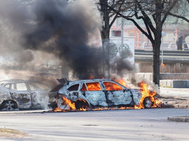 Two cars are burning in a parking lot during rioting in Norrkoping, Sweden on April 17, 20