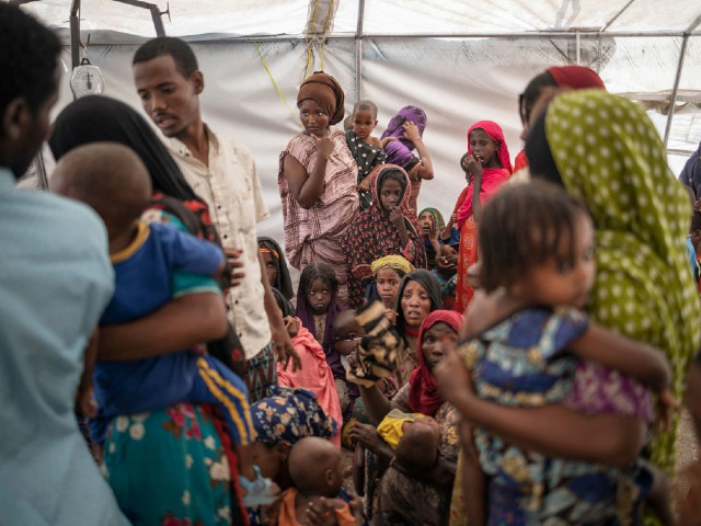 Internally displaced women from the internally displaced persons (IDP) camp of Guyah, 100 kms of Semera, Afar region, Ethiopia wait to have their children screened by helth personnel on May 17, 2022. - Conflict erupted in Ethiopia late 2020 when the government sent troops in to topple Tigray's ruling TPLF party, saying it was in response to rebel attacks on army camps. Hundreds of thousands have been driven to the brink of famine, more than two million people been displaced and more than nine million left in need of food aid. (Photo by Michele Spatari / AFP) (Photo by MICHELE SPATARI/AFP via Getty Images)