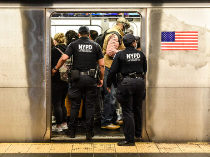 New York Police Department (NYPD) officers enter a subway at a station in New York, US, on Wednesday, May 25, 2022. New York City's subway system is carrying fewer riders than expected this year as crime has spiked, including a fatal shooting on Sunday and a violent subway attack last …