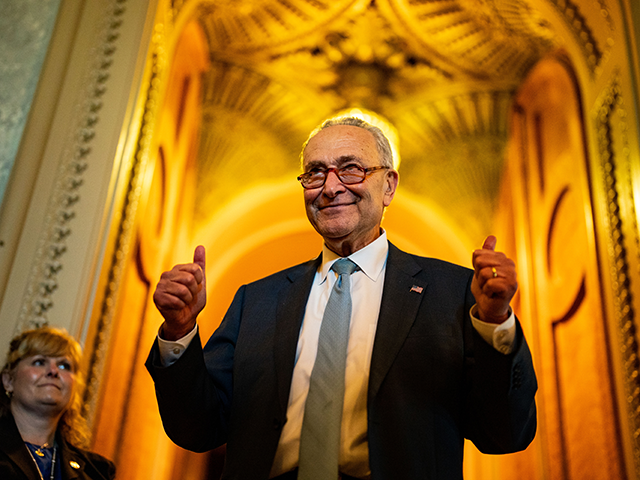 Senate Majority Leader Chuck Schumer (D-NY) gestures, walking out of the Senate Chamber, celebrating the passage of the Inflation Reduct Act at the U.S. Capitol on Sunday, Aug. 7, 2022 in Washington, DC. The Senate worked overnight Saturday into Sunday as they moved toward final passage of Senate budget reconciliation …