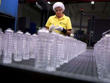 Quality controller Michaela Trebes inspects flacons on an assembly line at the German glass producer Heinz-Glas Group in Kleintettau, Germany on August 3, 2022. (Photo by Ronny Hartmann / AFP) (Photo by RONNY HARTMANN/AFP via Getty Images)