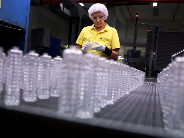 Quality controller Michaela Trebes inspects flacons on an assembly line at the German glas