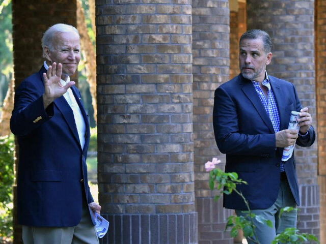 US President Joe Biden (L) waves alongside his son Hunter Biden after attending mass at Ho