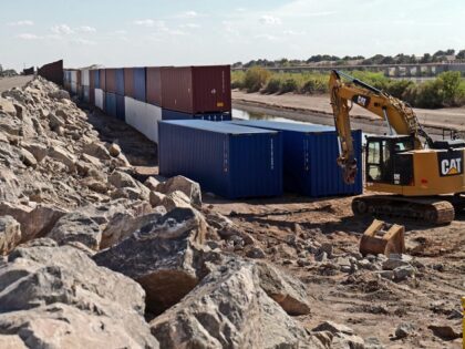 SAN LUIS, AZ - August 19: Shipping containers block a void in the wall as that prevent mig