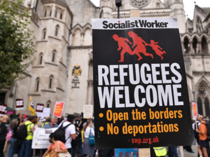 LONDON, UNITED KINGDOM - 2022/09/05: A placard which states Refugees Welcome is seen during the demonstration. Protesters gathered opposite The Royal Courts Of Justice on the first day of a High Court challenge over the Rwanda Deal agreement, which would see the UK forcibly send asylum seekers to Rwanda. (Photo …