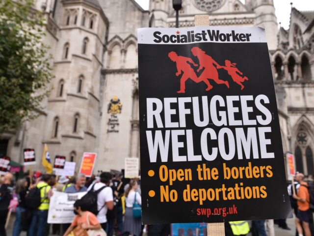 LONDON, UNITED KINGDOM - 2022/09/05: A placard which states Refugees Welcome is seen durin